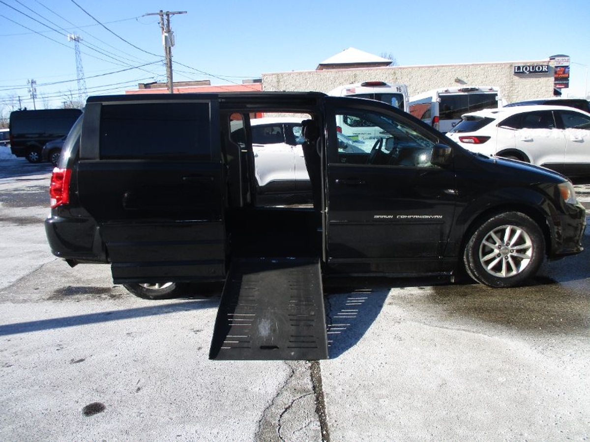 Black Dodge Grand Caravan with Side Entry Manual Fold Out ramp