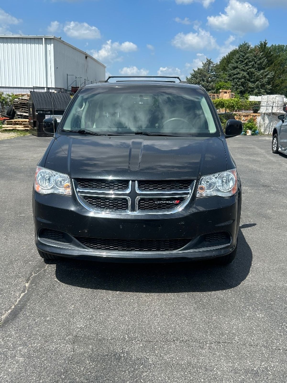 Black Dodge Grand Caravan with Side Entry Automatic Fold Out ramp