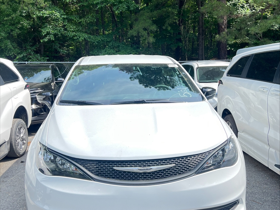 White Chrysler Voyager with Rear Entry Manual Fold Out ramp