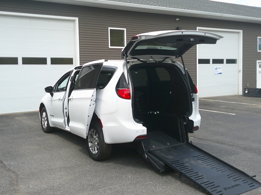 White Chrysler Voyager with Rear Entry Manual Fold Out ramp