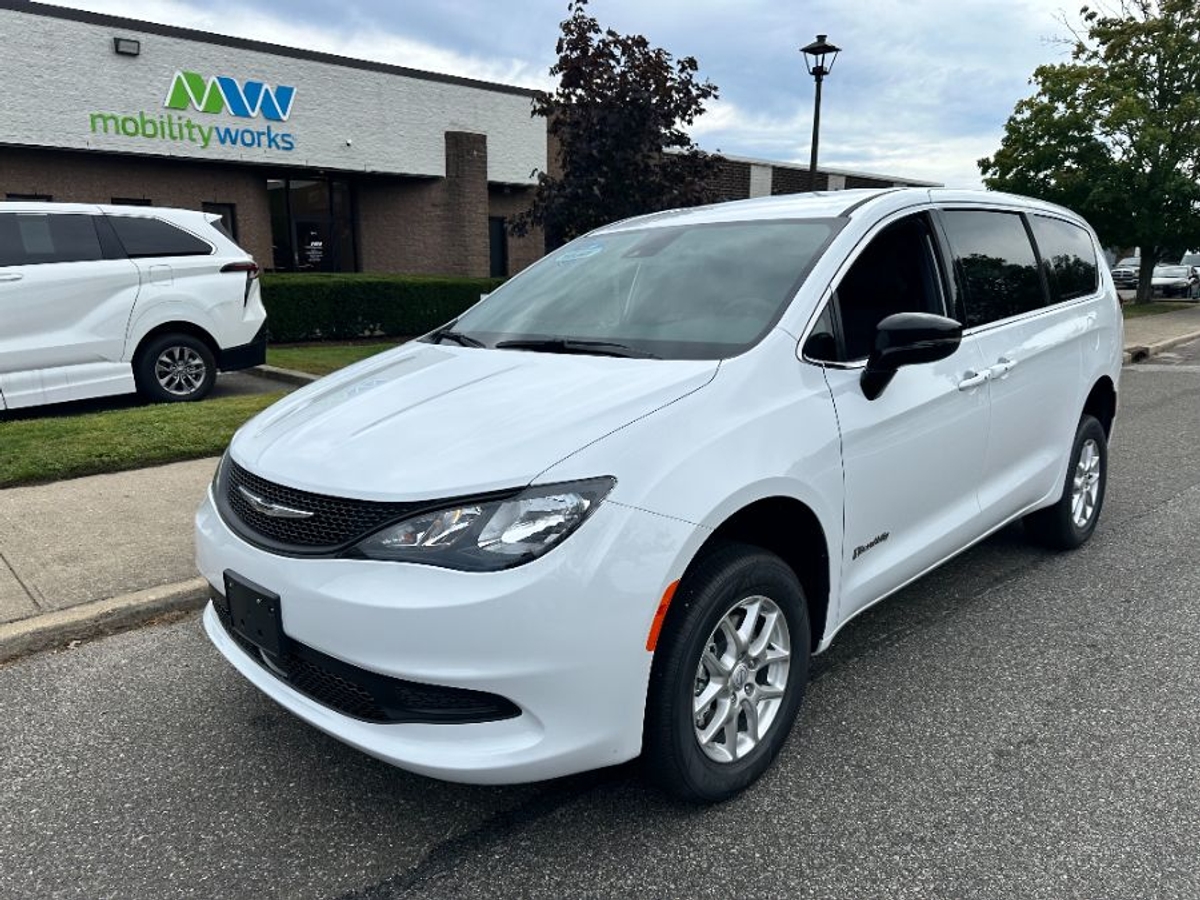 White Chrysler Voyager with Rear Entry Manual Fold Out ramp