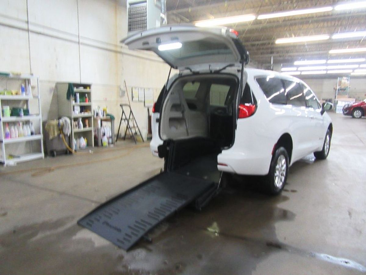 White Chrysler Voyager with Rear Entry Manual Fold Out ramp