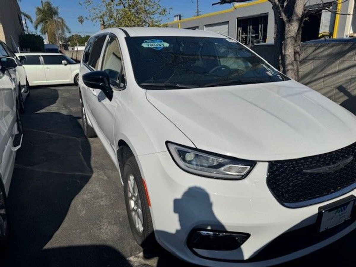White Chrysler Voyager with Rear Entry Manual Fold Out ramp