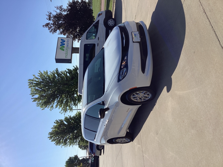 White Chrysler Voyager with Rear Entry Manual Fold Out ramp