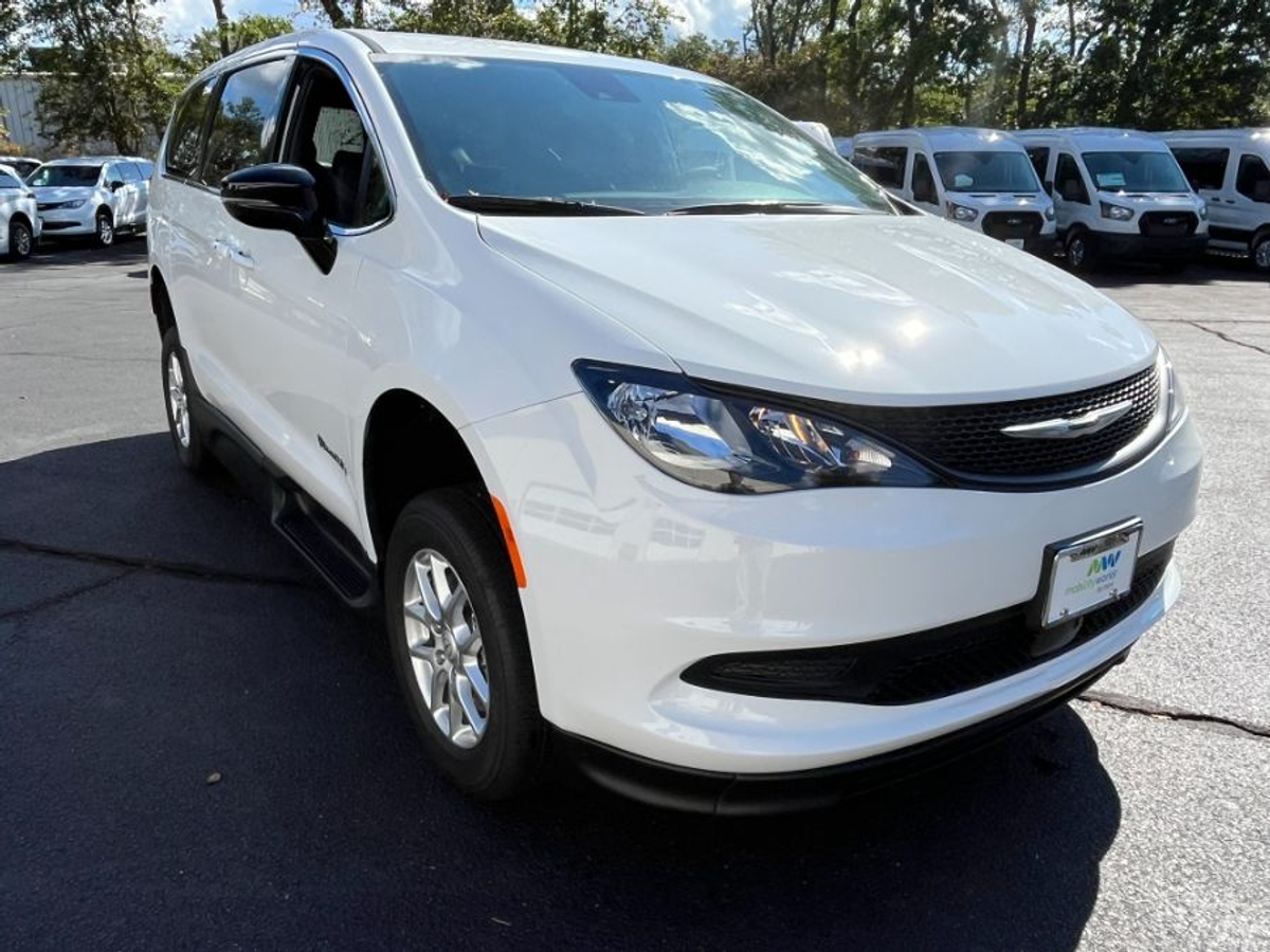 White Chrysler Voyager with Side Entry Manual Fold Out ramp