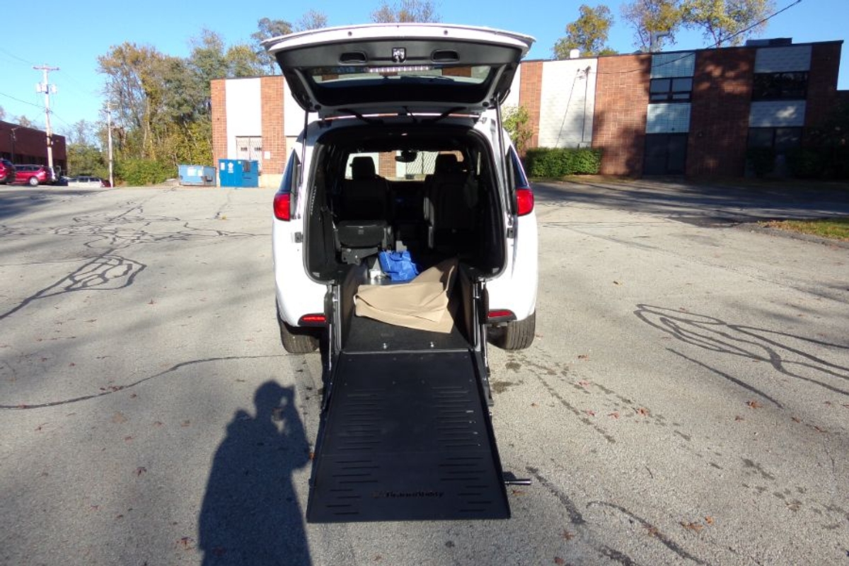 White Chrysler Voyager with Rear Entry Manual Fold Out ramp