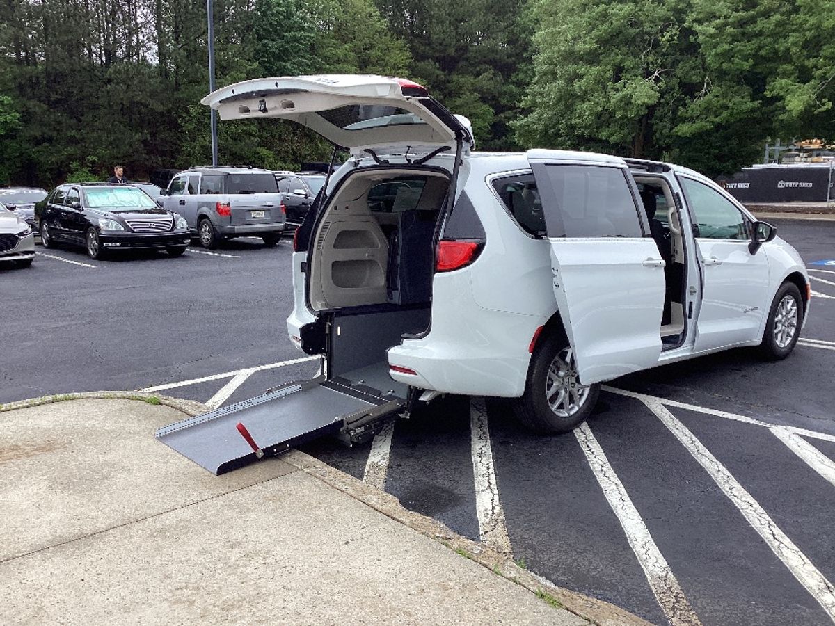 White Chrysler Voyager with Rear Entry Manual Fold Out ramp