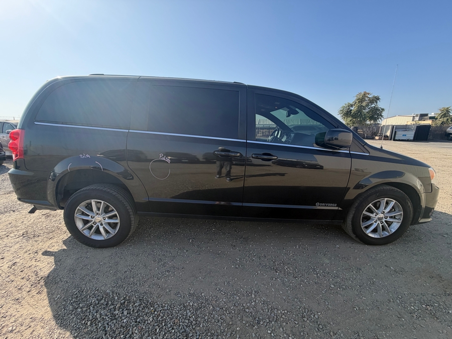 Black Dodge Grand Caravan with Rear Entry Manual Fold Out ramp