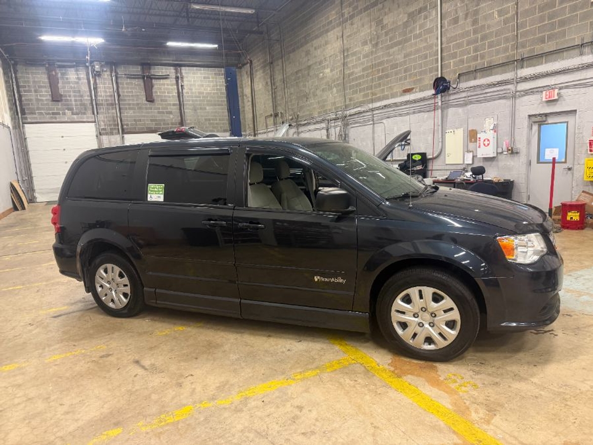Black Dodge Grand Caravan with Side Entry Automatic Fold Out ramp