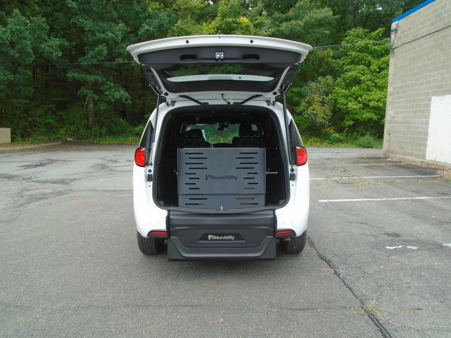 White Chrysler Voyager with Rear Entry Manual Fold Out ramp