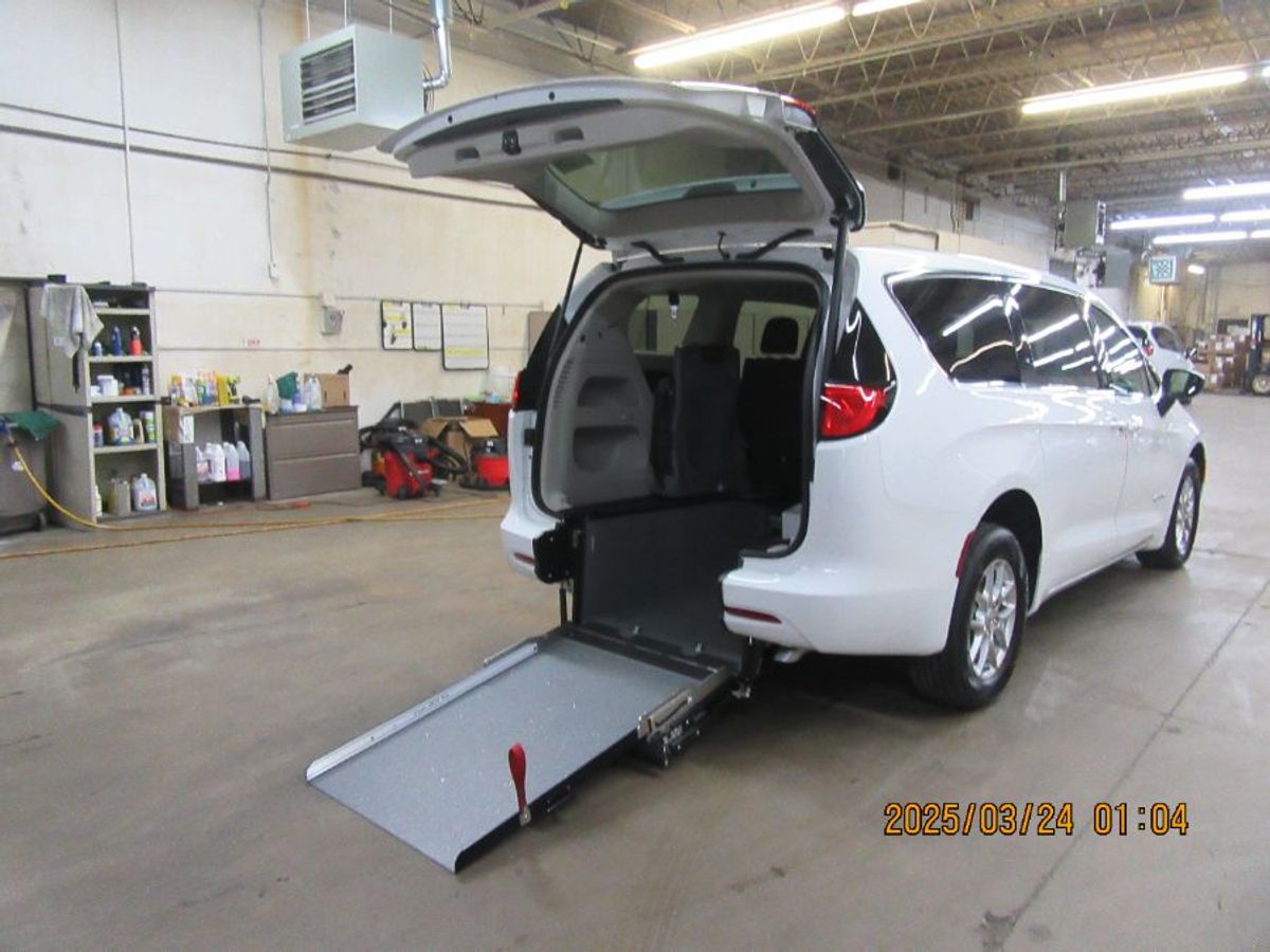 White Chrysler Voyager with Rear Entry Manual Fold Out ramp