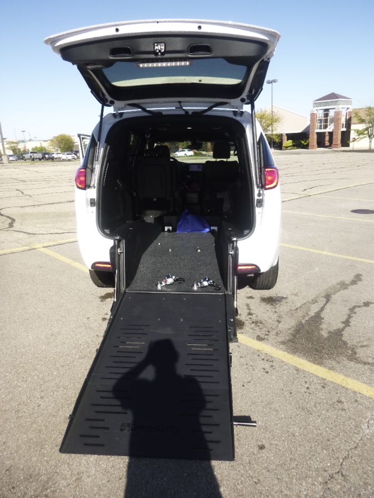 White Chrysler Voyager with Rear Entry Manual Fold Out ramp