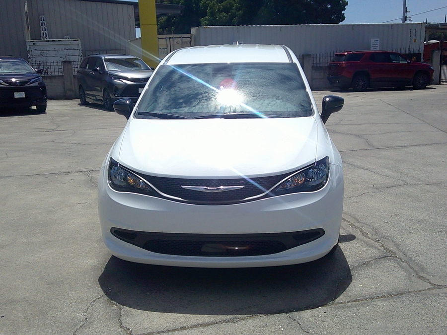 White Chrysler Voyager with Rear Entry Manual Fold Out ramp