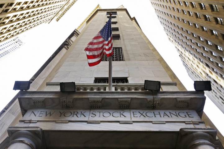 FILE - In this Friday, Nov. 13, 2015, file photo, the American flag flies above the Wall Street entrance to the New York Stock Exchange. Stocks are opening modestly lower on Wall Street, Thursday, Feb. 2, 2017, as traders didn't find much to get excited about in the latest batch of earnings reports from U.S. companies. (AP Photo/Richard Drew, File)