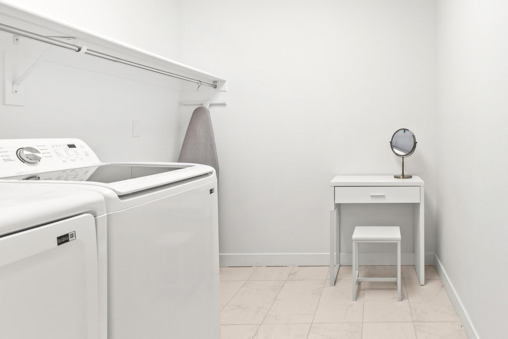 A bright, dedicated laundry space with washer and dryer makes keeping your vacation wardrobe fresh effortless, plus a vanity for your convenience.