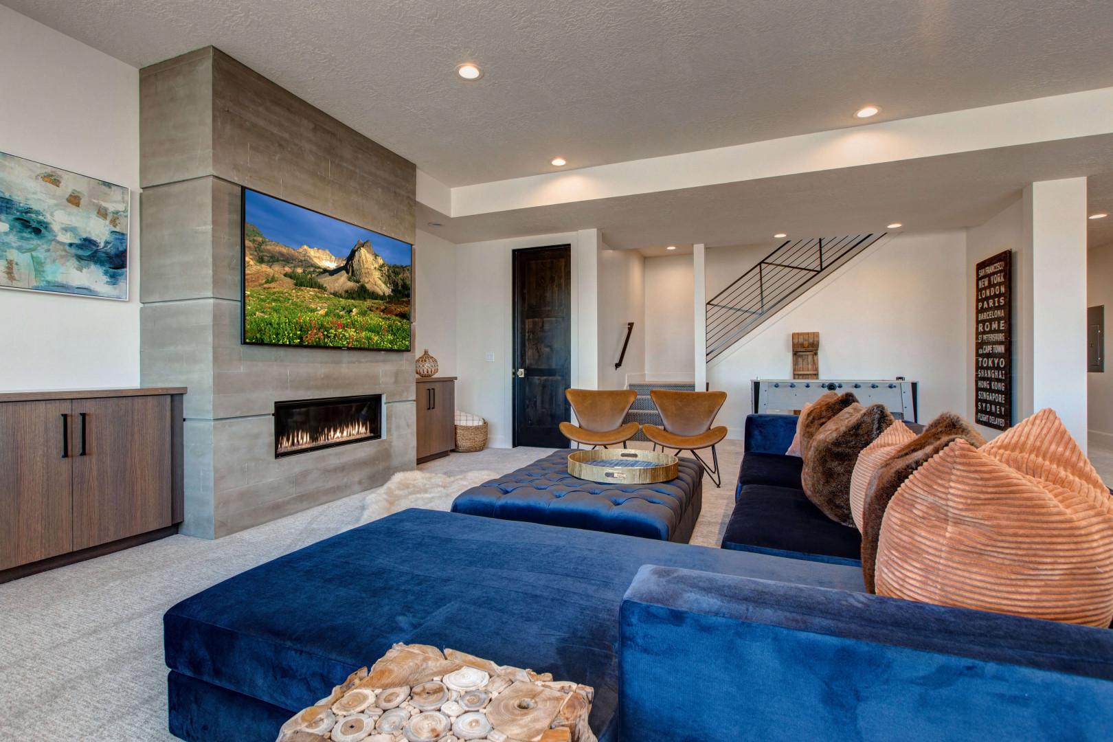 Cozy space with a fireplace, TV, and stylish sofa set.