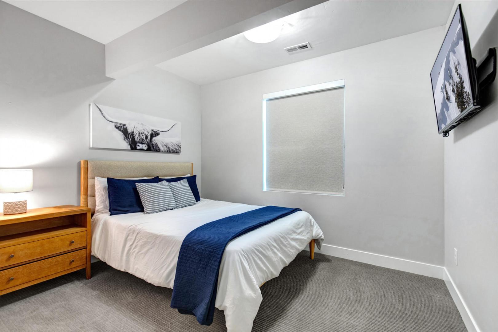Settle into your serene bedroom, where crisp linens and contemporary décor invite restful nights after exploring the area.