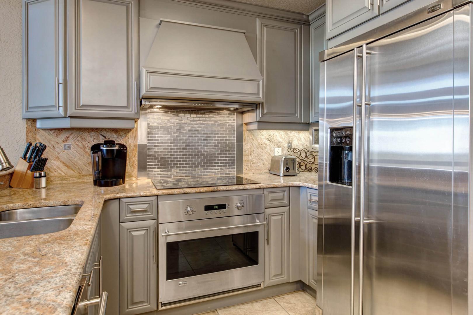 Modern appliances and ample storage in sleek kitchen design.