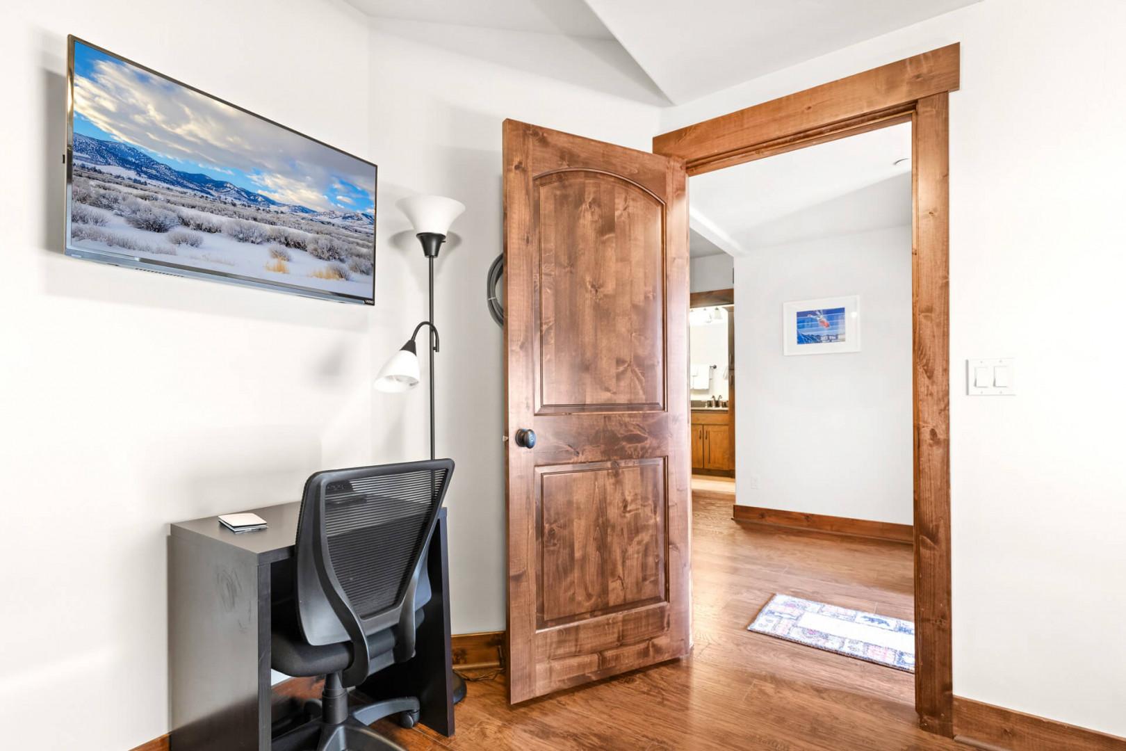 Your perfect workspace awaits with modern amenities and rustic charm, featuring a wall-mounted TV for entertainment between productive sessions.