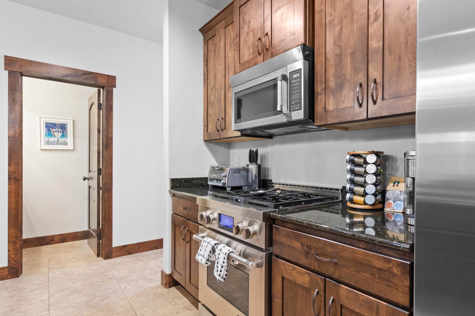 Your fully equipped kitchen features warm wood cabinetry, granite countertops, and stainless steel appliances for all your culinary adventures.