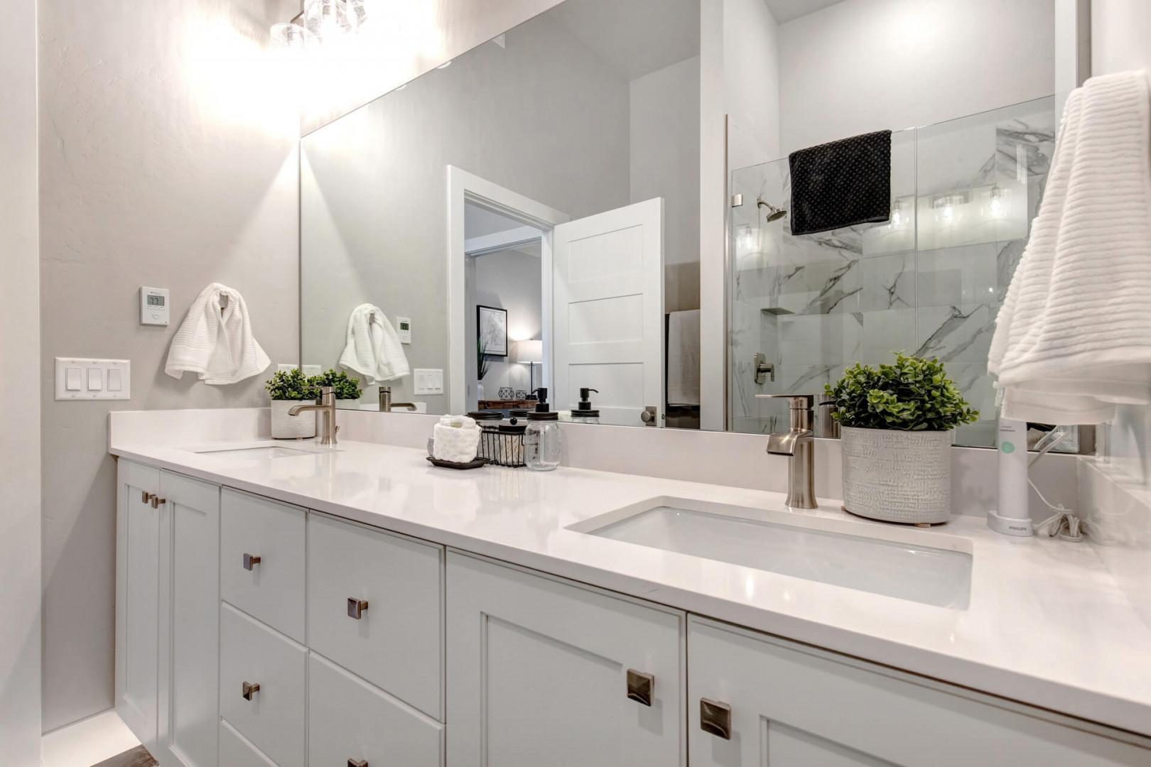 Reflective sink area with a sleek mirror, perfect for morning routines.