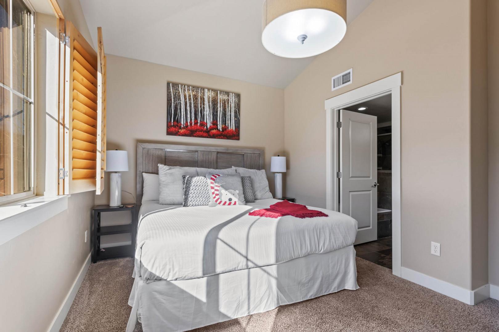 Bear Hollow 1404: Sunlight streaming through window onto cozy bed, inviting relaxation and rest.