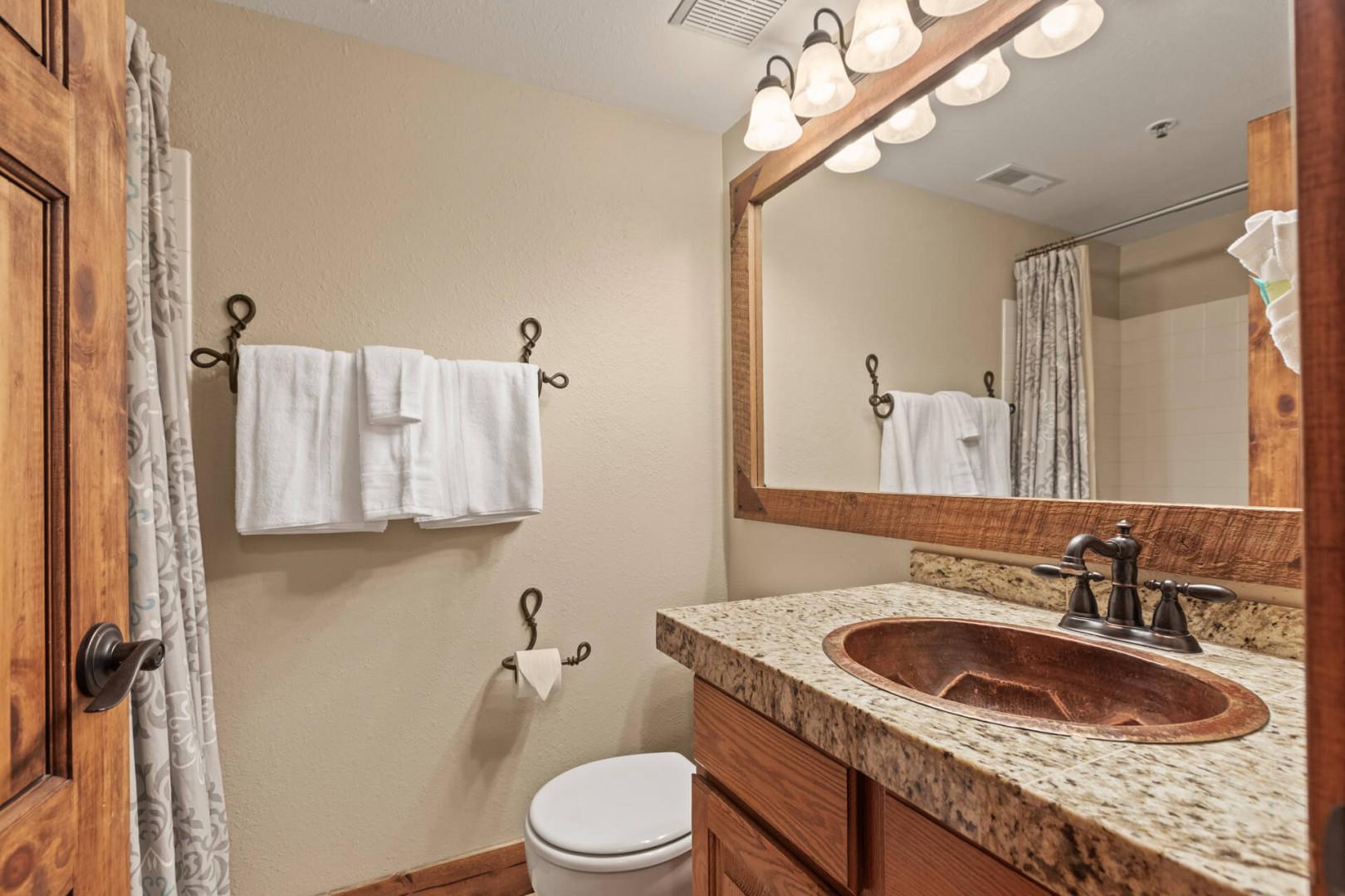 Powderwood 11C: Clean sink and toilet in a well-lit space.