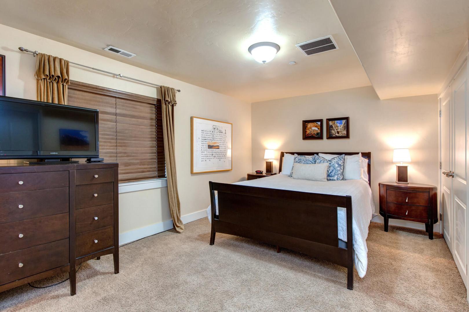 Unwind in your spacious bedroom featuring rich wood furnishings, crisp linens, and warm lighting that creates the perfect retreat.