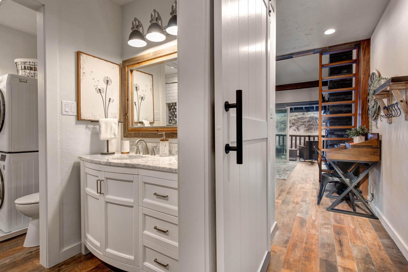 Reflective sink area with a sleek mirror, perfect for morning routines.