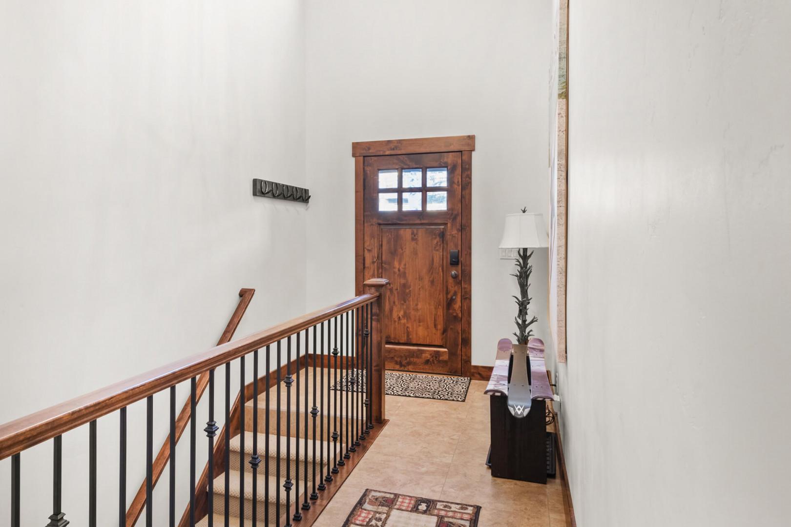 Step into your welcoming upstairs hallway, where warm wood tones and thoughtful touches create a cozy mountain retreat atmosphere.