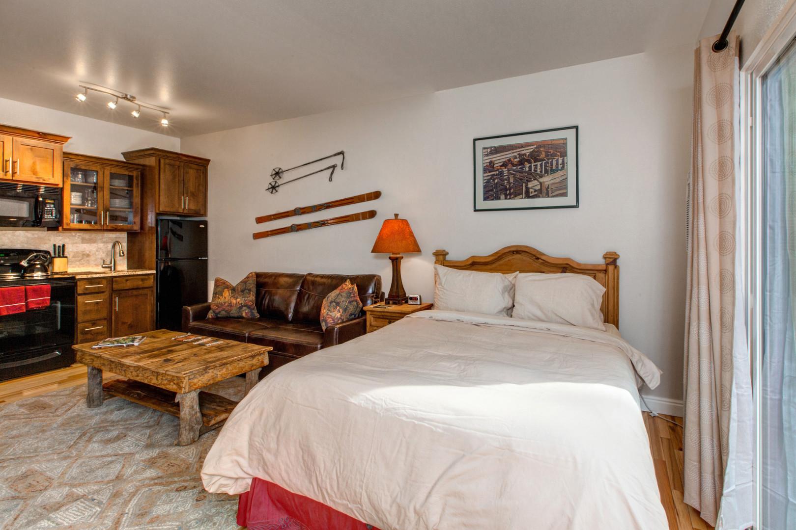 Cozy queen bed next to versatile sofa bed in stylish room.