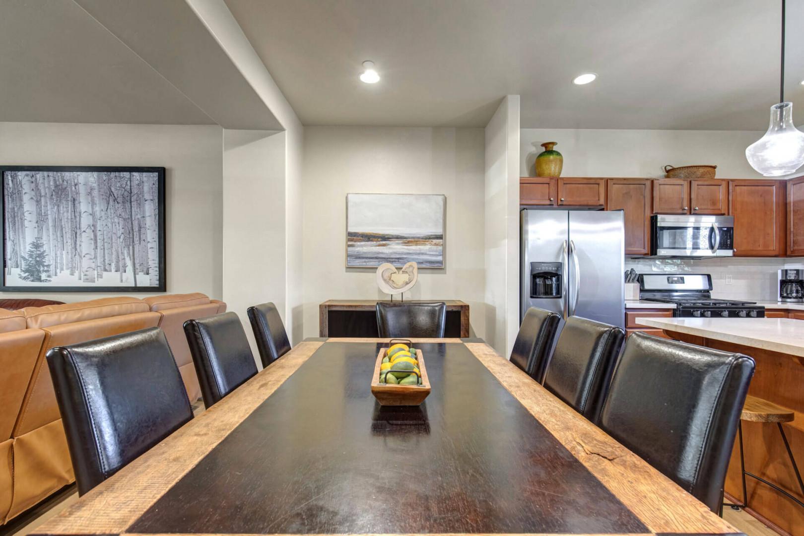 Gather around your spacious dining table for memorable meals, with sleek leather seating and an open kitchen perfect for entertaining.