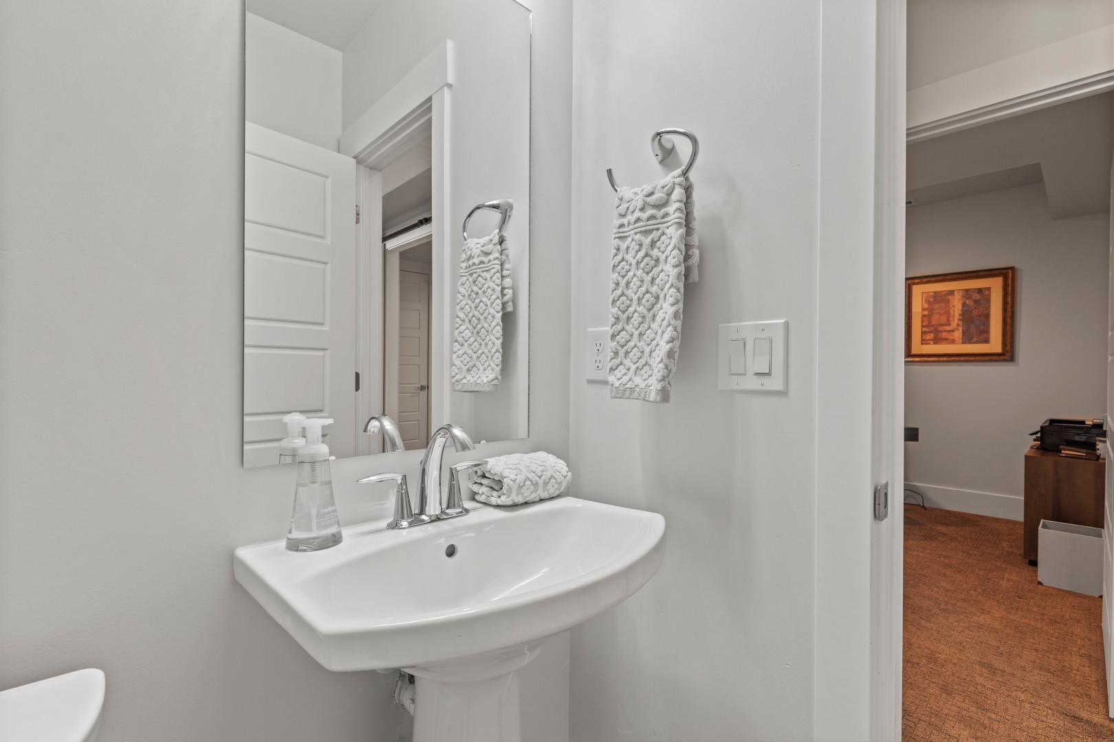 Deer Springs 12797: Reflective sink area with a sleek mirror, perfect for morning routines.