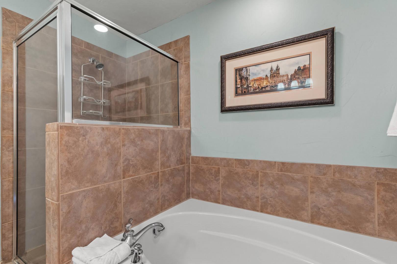 Bear Hollow Lodge 1401: Step-in shower and luxurious tub in the bathroom attached to the primary bedroom.