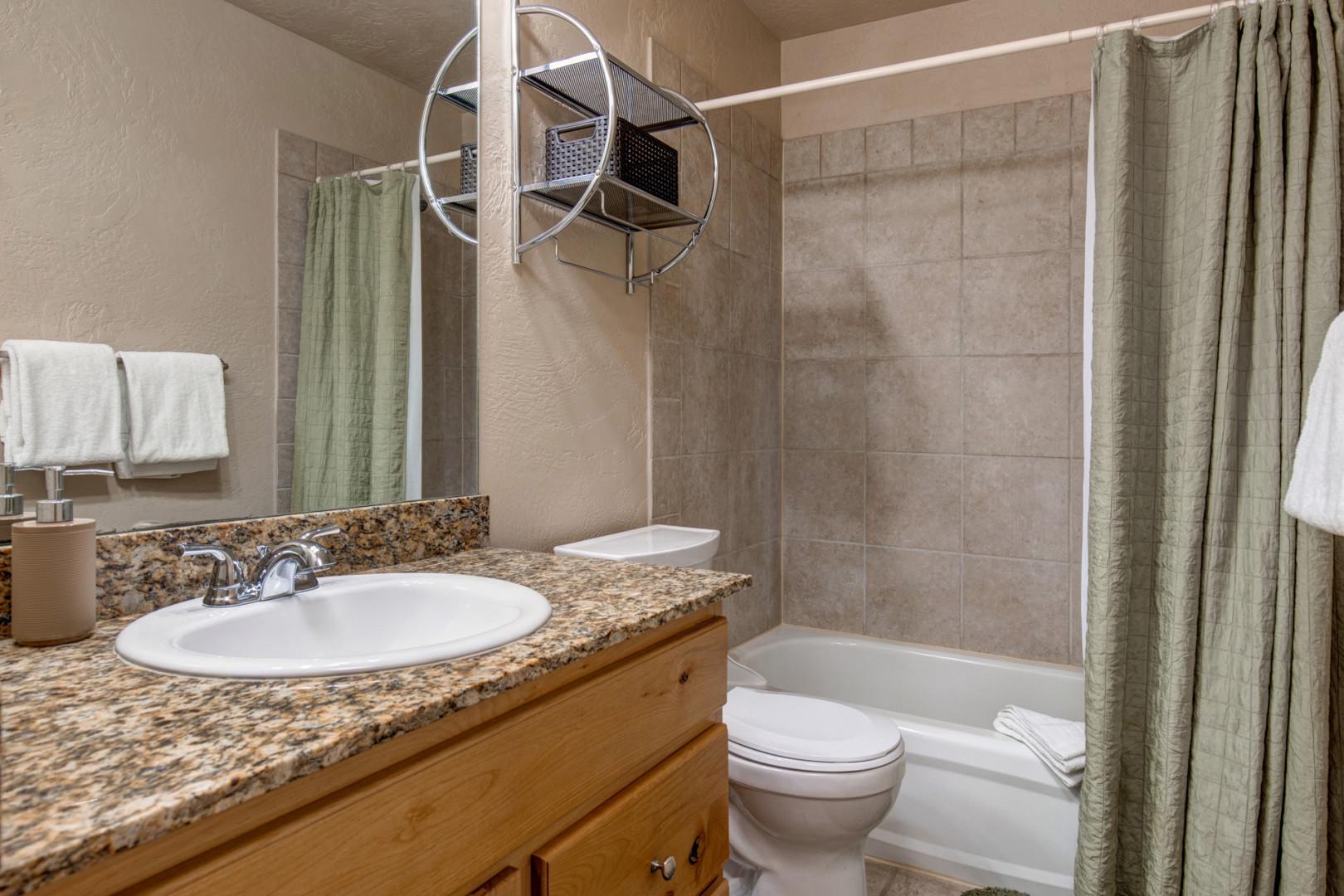 Foxpoint 1684-H3- Sleek sink, mirror, toilet, and convenient tub shower combo.