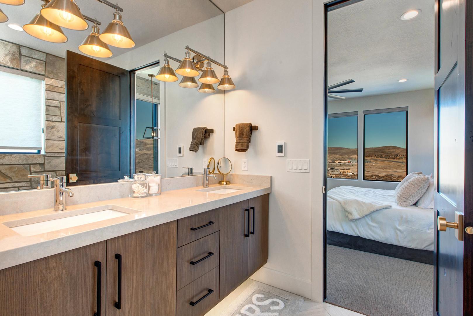 Jordanelle Estates 13201: Reflective sink area with a sleek mirror, perfect for morning routines.