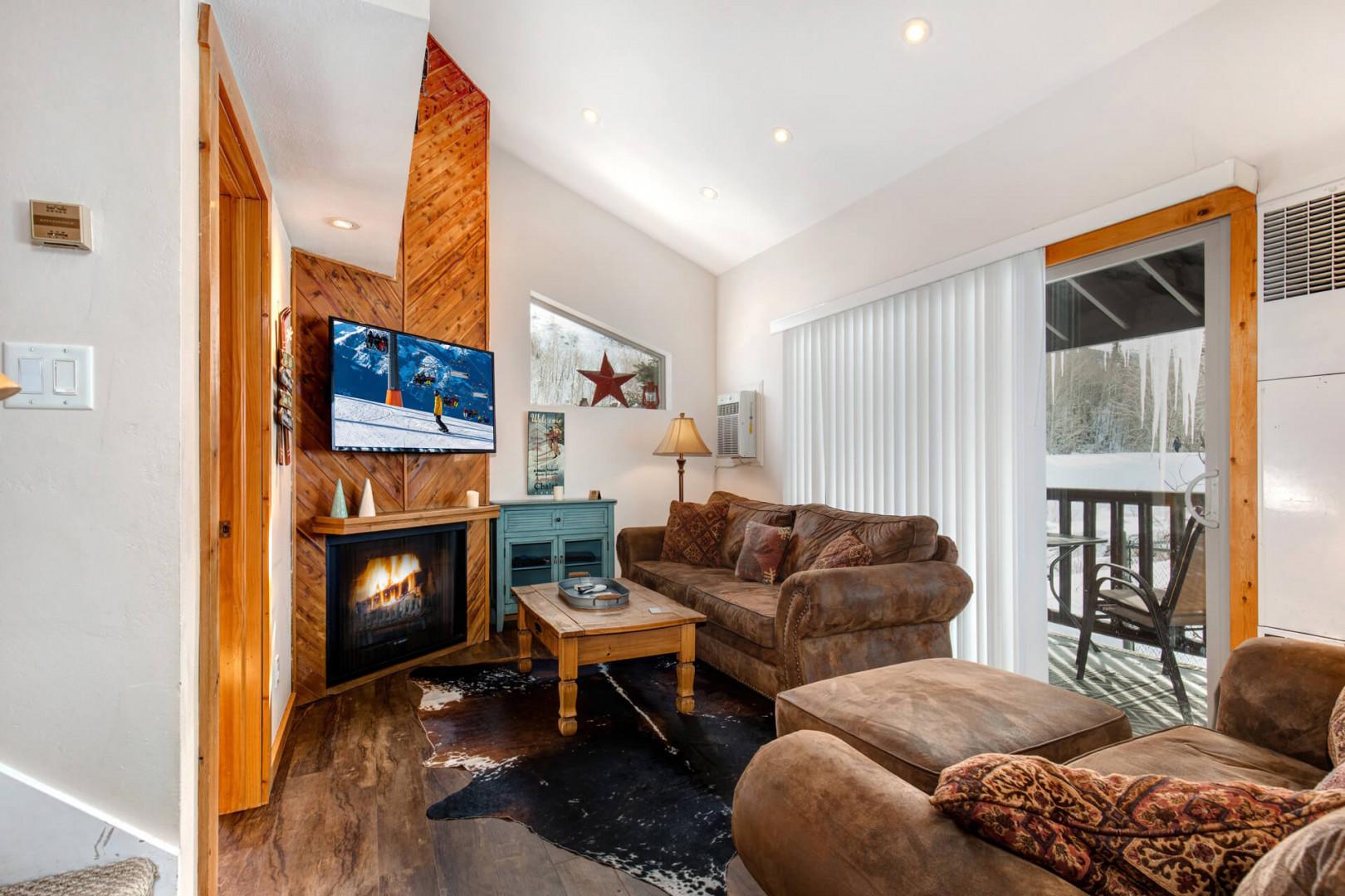 Living Room: "Cozy space with a sofa set, electric fireplace, and a view."