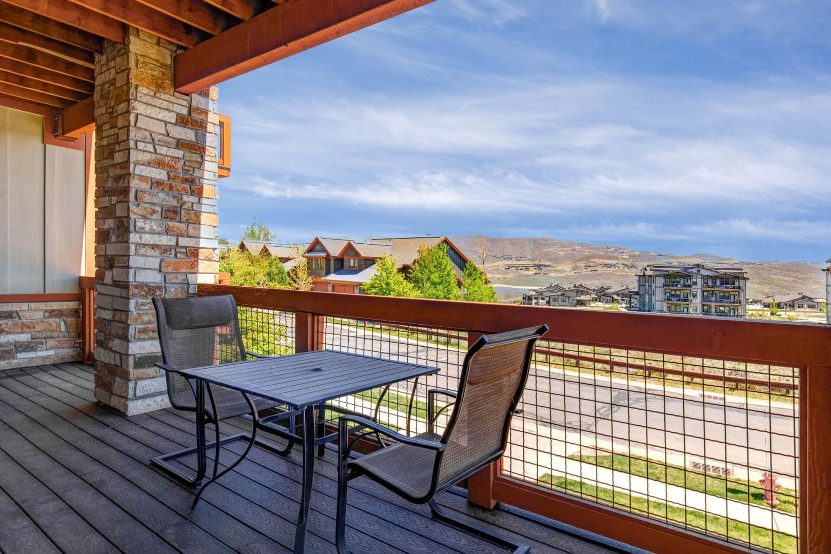 Private balcony featuring mountain views and a dining table perfect for morning coffee or evening relaxation under the covered patio.