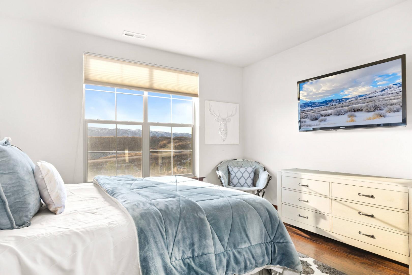 Wake up to breathtaking mountain views in this serene bedroom, where soft linens and natural light create your perfect retreat.