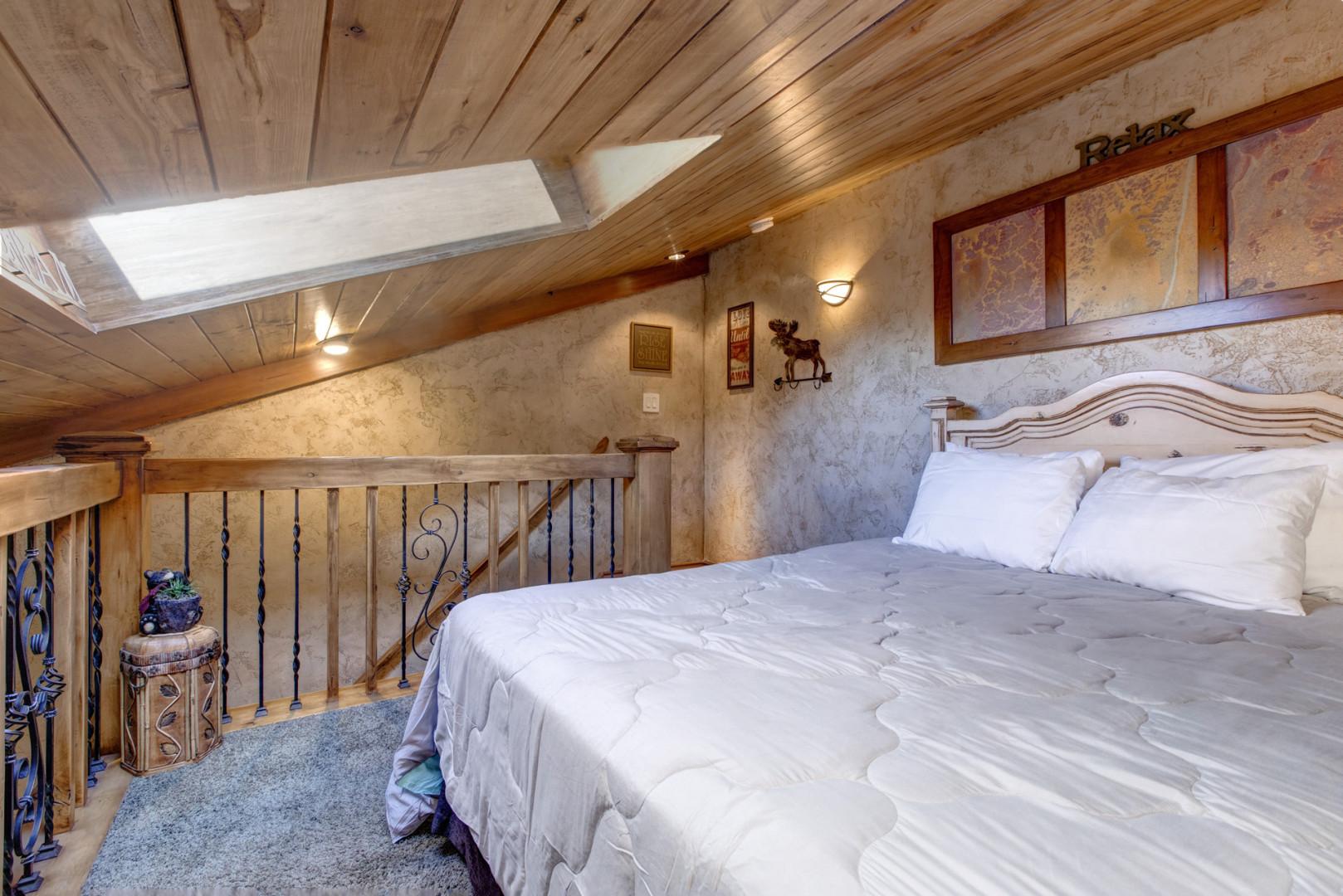 Loft: "Cozy queen bed tucked away under the eaves."