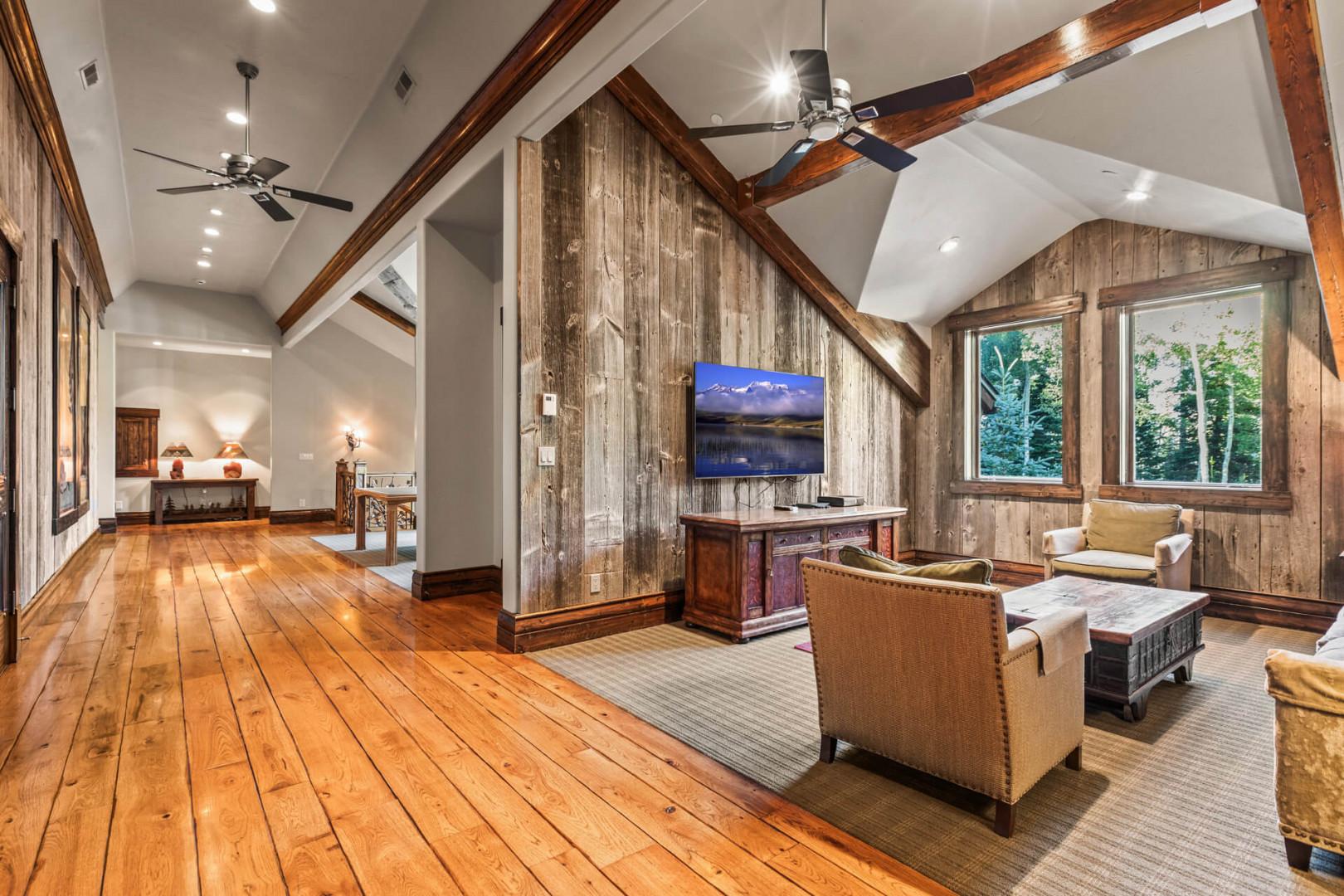 Sleek sofa set and high ceiling create a cozy ambiance.