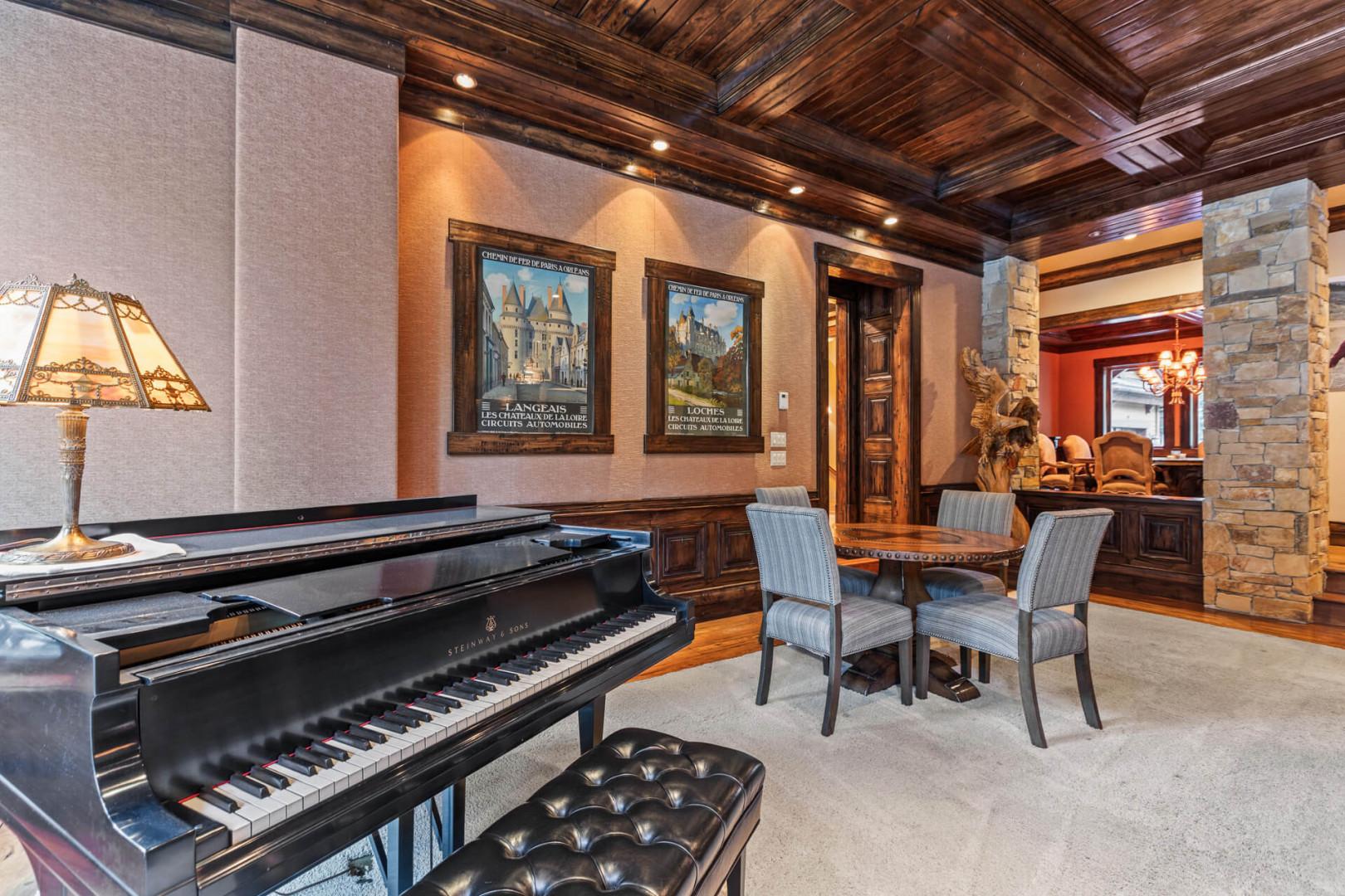 Piano, table, chairs, glass door to outdoor patio. Cozy vibes.