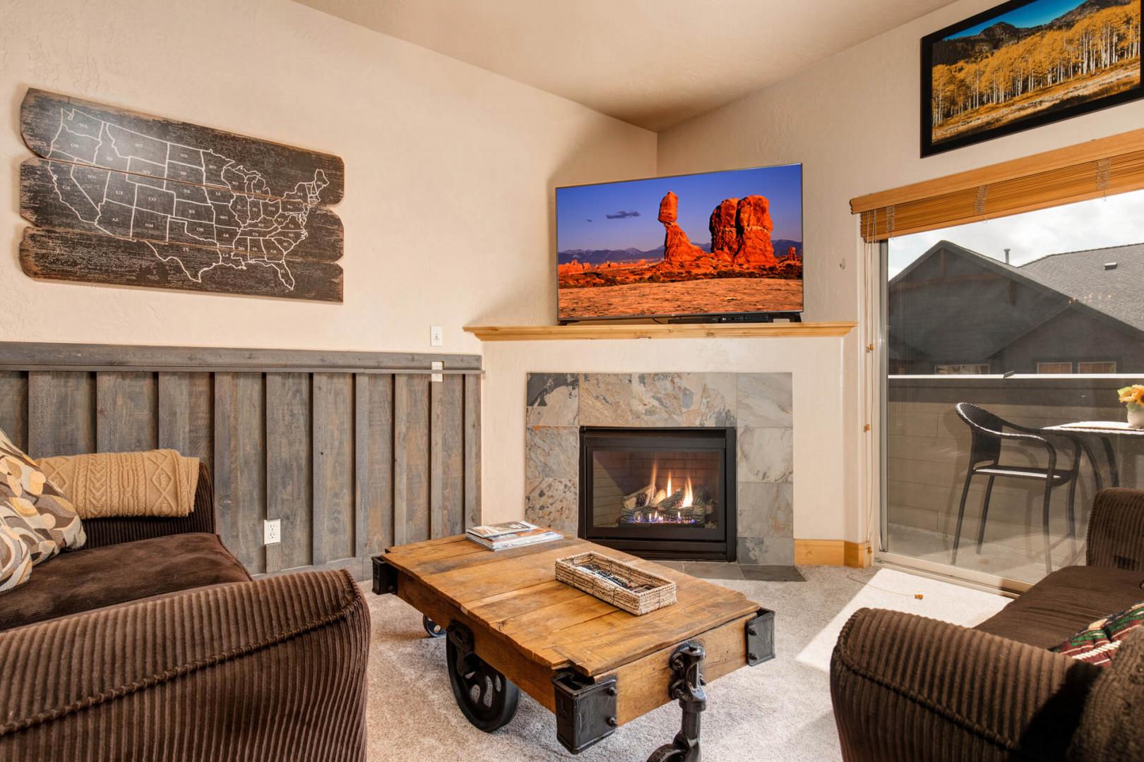 1684 Fox Hollow #H3_12: Cozy ambiance with fireplace, perfect for relaxing by the window.