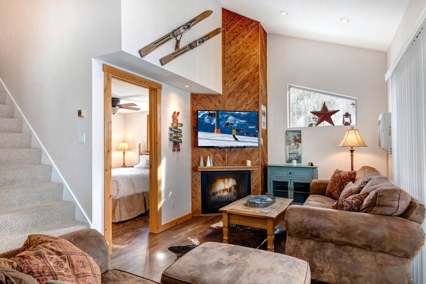 Living Room: "Cozy space with a sofa set, electric fireplace, and a view."