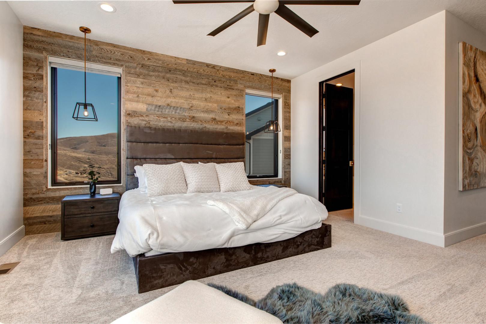 Jordanelle Estates 13201: Cozy bed by the window, perfect for a relaxing afternoon nap.