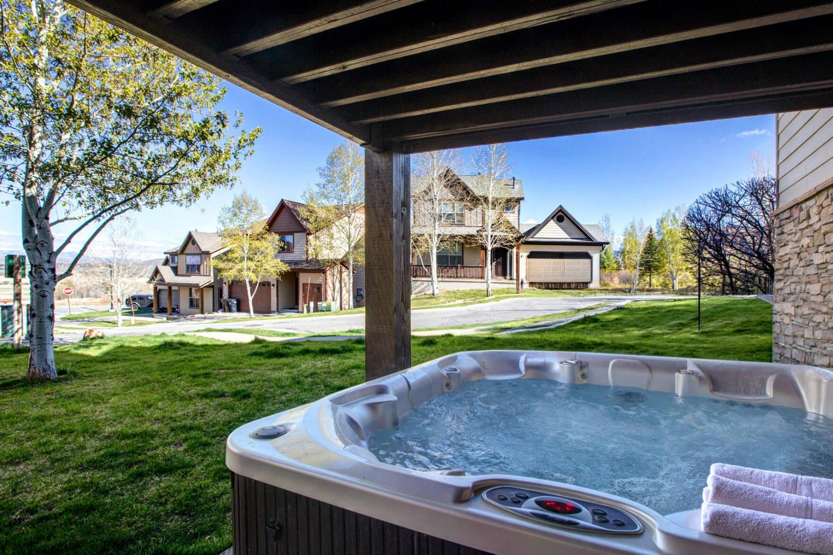 Soak in your private hot tub under rustic beams while overlooking peaceful neighborhood views—perfect for unwinding after exploring.