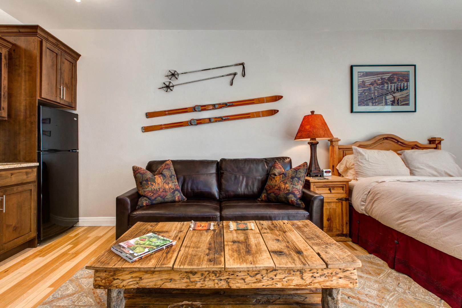 Charming sofa bed and center table beside the queen bed.