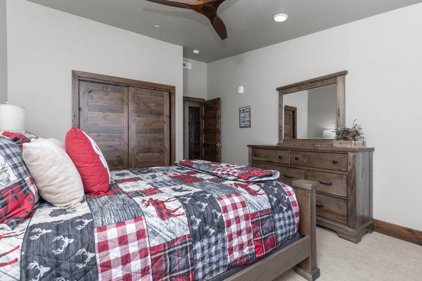 Cozy bed bathed in natural light from the large windows.