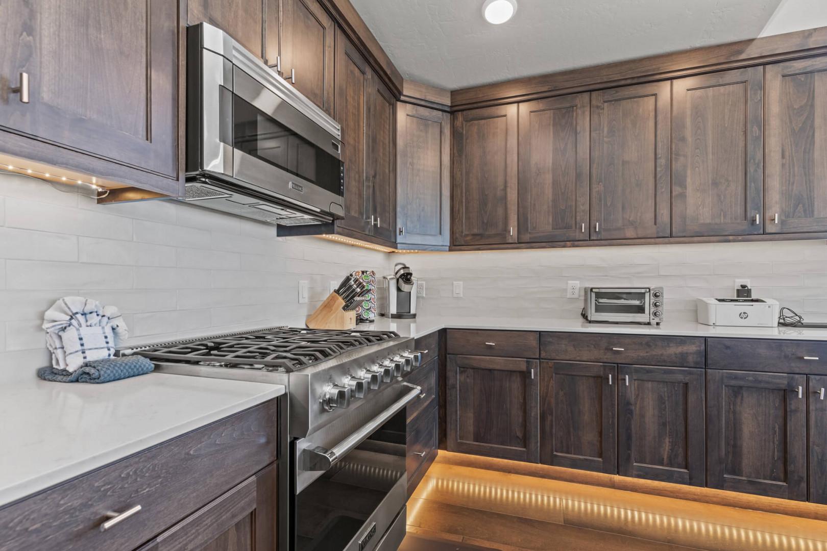 Modern appliances and ample storage in sleek kitchen design.