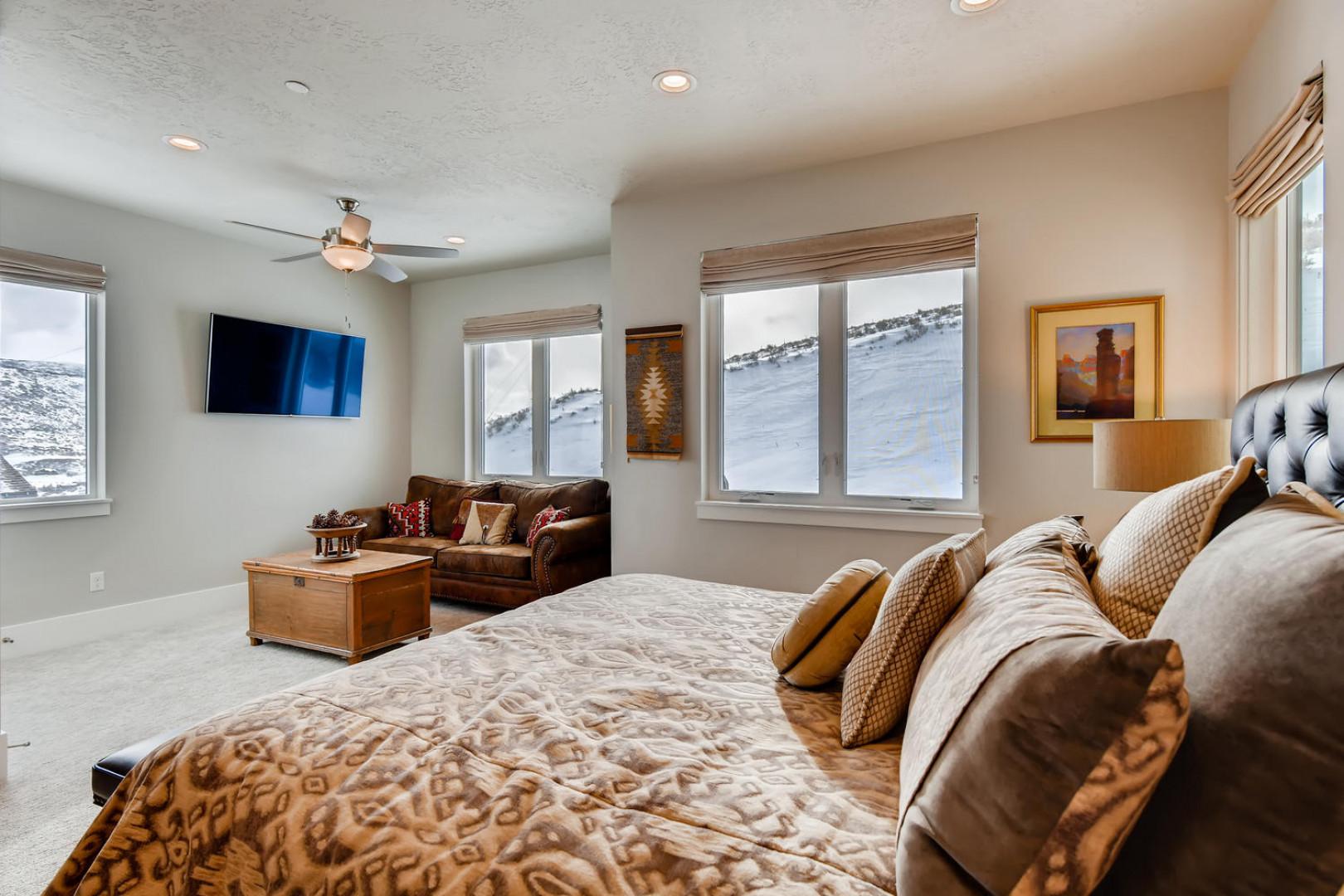 Jordanelle Estates 13299: Cozy bed by the window, inviting sofa for relaxation.